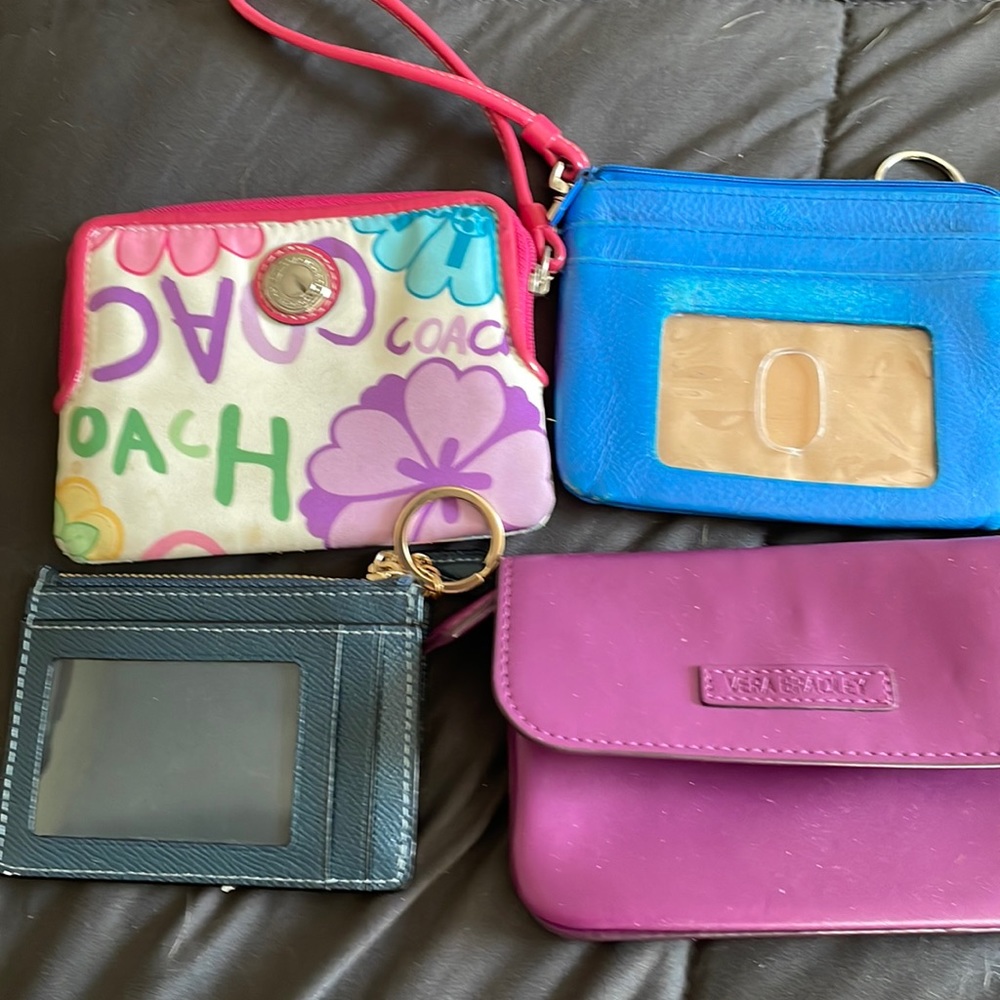 4 small wallets. 1 no name blue 1 vera bradley 2 coach